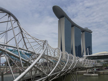 Low angle view of bridge by marina bay sands against sky