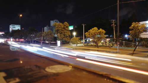 Illuminated city street at night