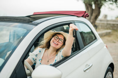 Portrait of young woman in car