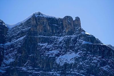 Low angle view of snowcapped mountain against sky