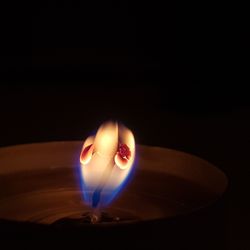 Close-up of illuminated lamp in darkroom