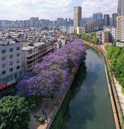 High angle view of canal amidst buildings against sky