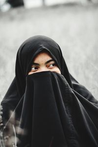 Portrait of woman covering face