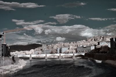 Bridge over cityscape against sky