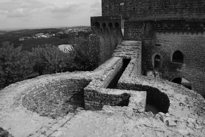 Shadow of old ruin on mountain against sky