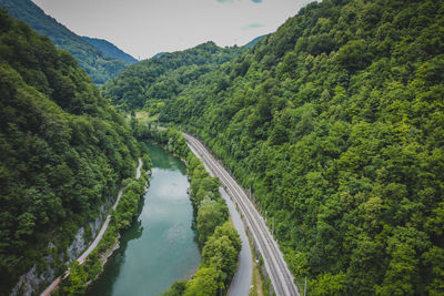 High angle view of river amidst trees against sky