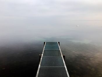 Pier over lake against sky