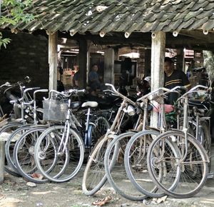 Old bicycle parked in front of wall