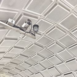 Low angle view of security cameras against ceiling