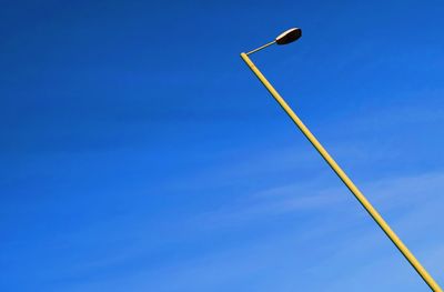 Low angle view of street light against blue sky