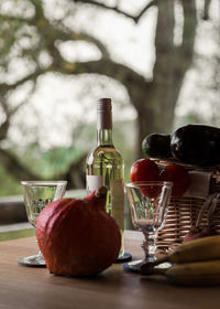 Close-up of white wine bottle and vegetables on table