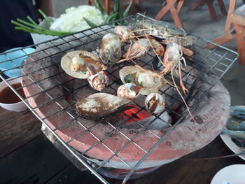 High angle view of meat on barbecue grill