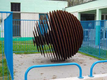 Close-up of metal fence against building