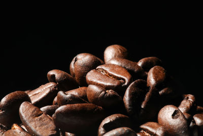 Close-up of coffee beans against black background