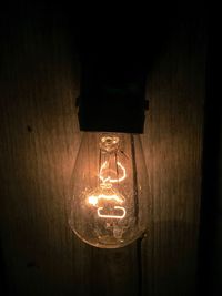 Close-up of illuminated lamp post at night