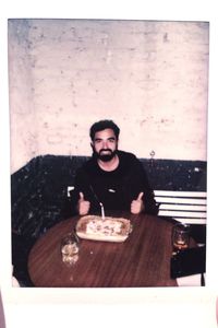 Portrait of smiling young man sitting in restaurant