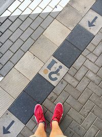 Low section of man standing on footpath