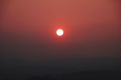 Scenic view of silhouette moon against sky during sunset