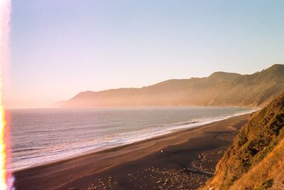 Scenic view of sea with mountains in background