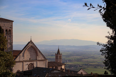 Panoramic view of temple and buildings against sky