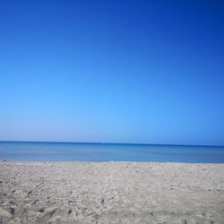 Scenic view of sea against clear blue sky