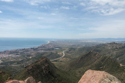 Scenic view of sea and mountains against sky