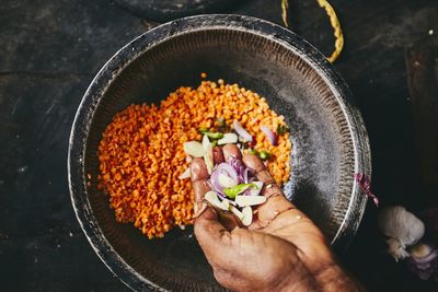 Cropped hand preparing food on table