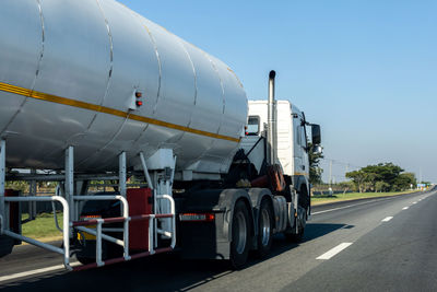 Vehicles on road against sky