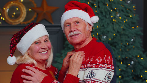 Portrait of smiling couple wearing santa hat