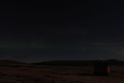 Scenic view of field against sky at night