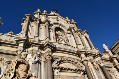 Low angle view of historic building against blue sky