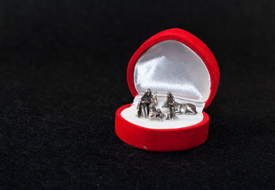 Close-up of figurines in jewelry box on table