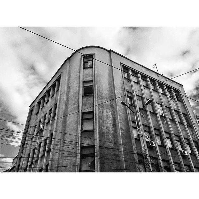 architecture, transfer print, built structure, building exterior, low angle view, auto post production filter, sky, building, window, cloud - sky, day, outdoors, no people, city, cloudy, cloud, reflection, brick wall, glass - material, exterior