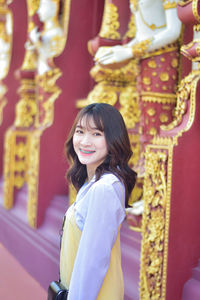 Portrait of young woman standing in temple