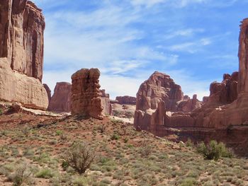 View of rock formation against cloudy sky