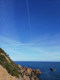 Scenic view of sea against blue sky