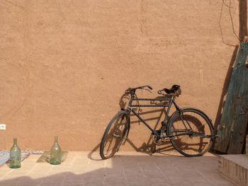 Bicycle parked against wall