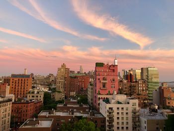 High angle view of buildings in town against sky during sunset