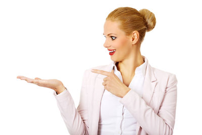 Smiling young woman against white background