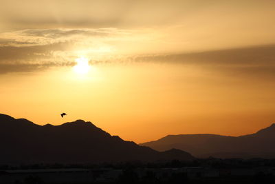 Scenic view of silhouette mountains against sky during sunset