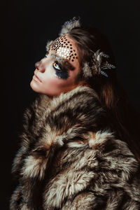 Close-up portrait of woman in animal face paint