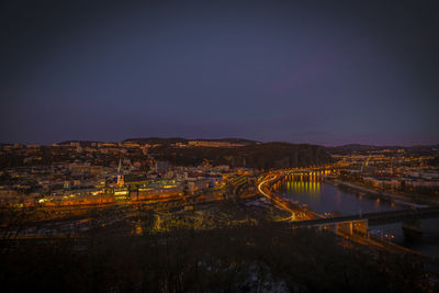 High angle view of illuminated cityscape against sky at night