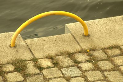 High angle view of yellow toy by swimming pool