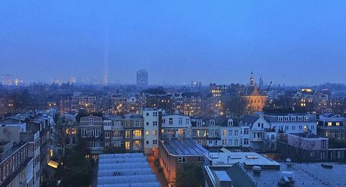 High angle view of illuminated cityscape against clear sky