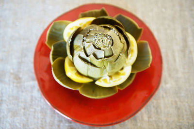 High angle view of artichoke in plate on table