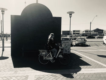 Side view of man riding bicycle on street