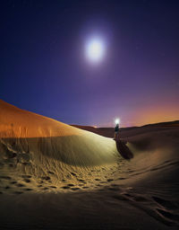 Scenic view of desert against sky at night