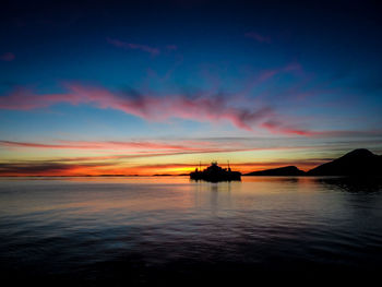 Scenic view of sea against sunset sky