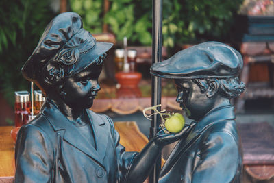 Close-up of statues with green tomato
