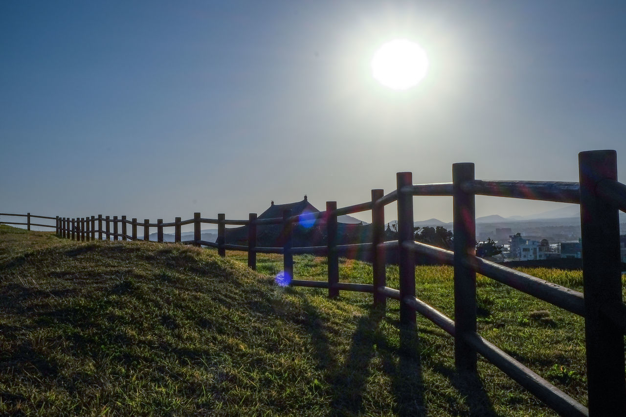 RAILING BY SEA AGAINST CLEAR SKY